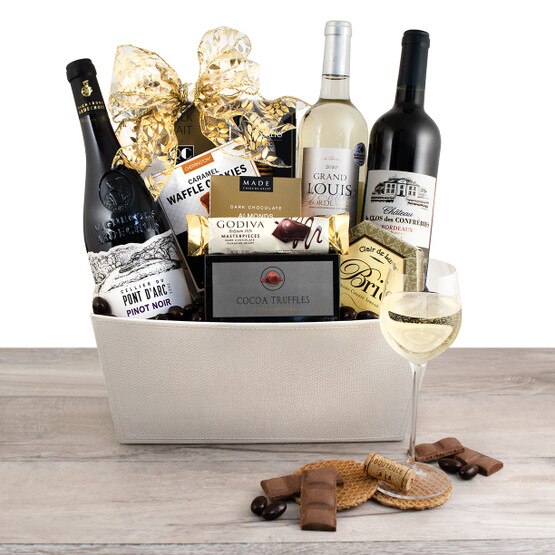 dark chocolates, lemon cakes and wine in rustic gift bucket